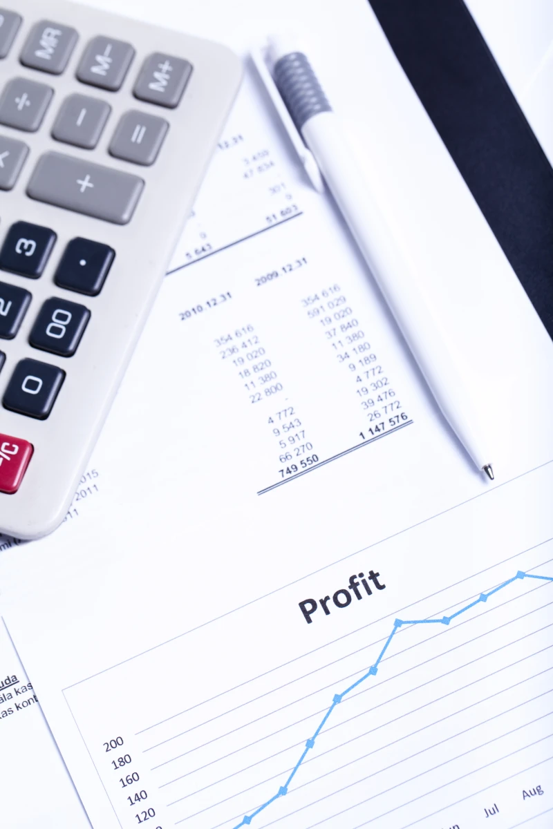 calculator on top of pile of bills and paperwork